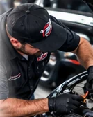 AI-generated illustrative mechanic inspecting an engine bay