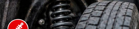 Illustrative suspension spring beside a vehicle tire